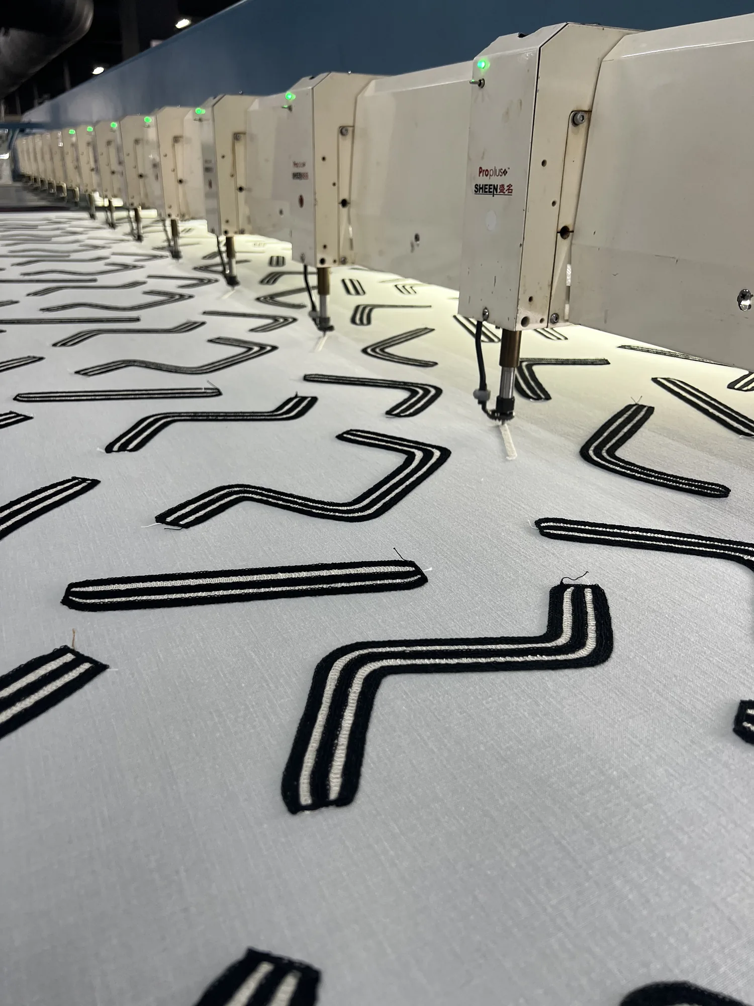 The factory floor, the fabric on the machine